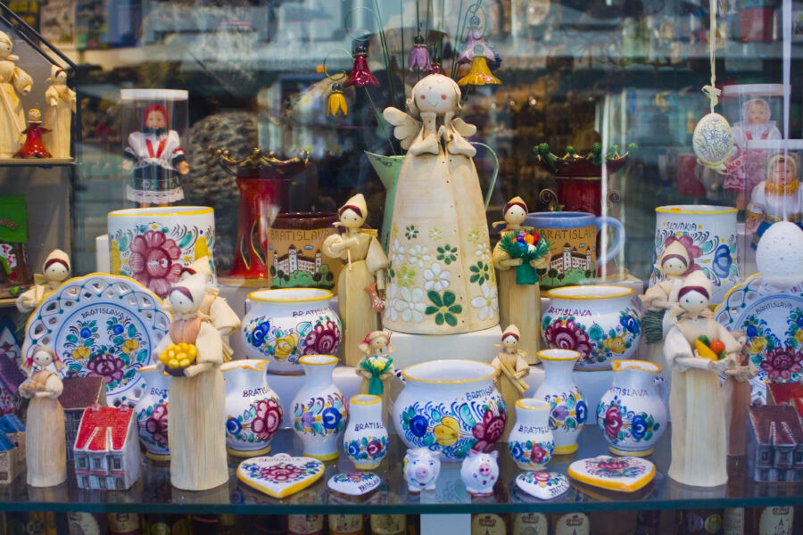 Display of ceramic souvenirs and dolls showcased in a shop in Bratislava