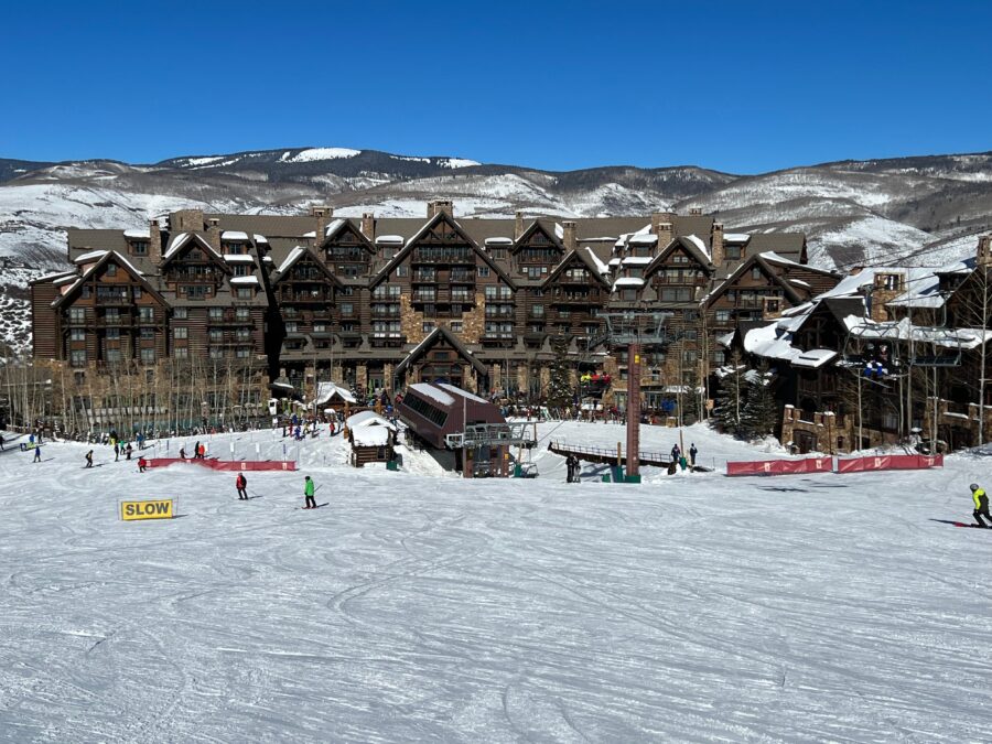 Base lodge at Peak 8, Breckenridge Ski Resort, featuring a rustic design and surrounded by snow-covered mountains