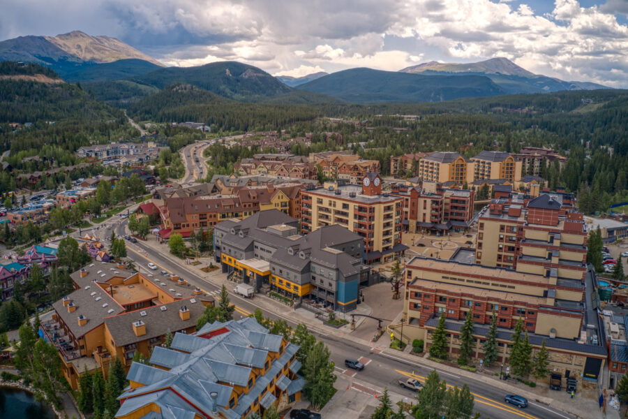 Aerial view of Breckenridge, Colorado, showcasing the ski resort town surrounded by snow-capped mountains and pine trees