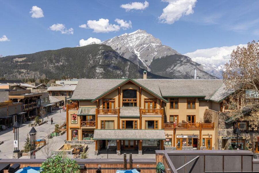 Scenic view from Brewster’s Mountain Lodge balcony, showcasing the majestic peaks and valleys of Banff, Canada.