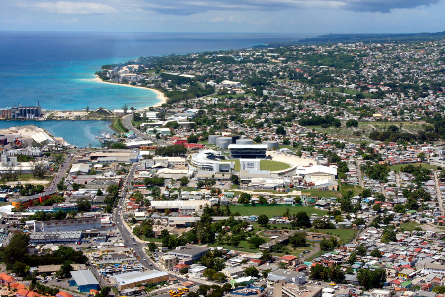 Aerial perspective of Bridgetown, Barbados, highlighting the colorful buildings and beautiful coastline of the Caribbean