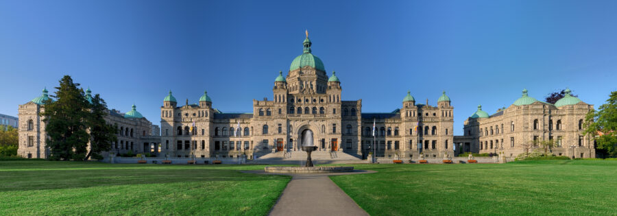The British Columbia Parliament Buildings in Victoria, showcasing stunning architecture and lush surrounding gardens.