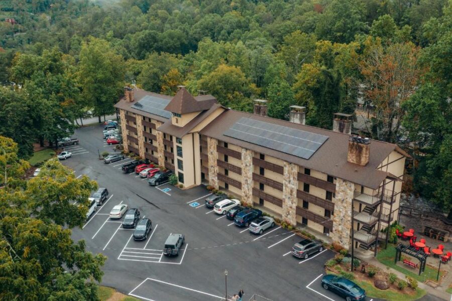 The scenic Brookside Lodge at the mountain's peak, showcasing colorful autumn leaves and a river view in Gatlinburg.
