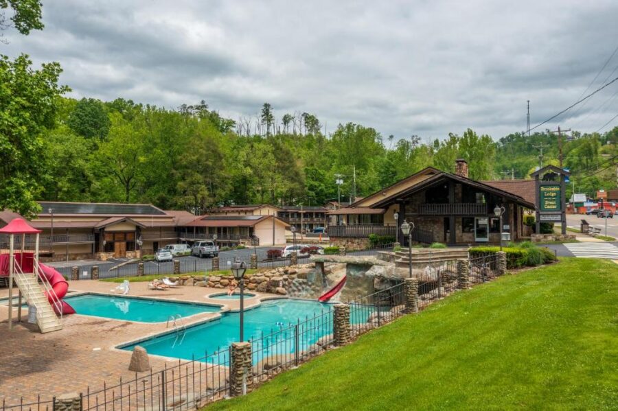 The pool at Brookside Lodge, a mountain resort in Gatlinburg, surrounded by lush greenery and scenic river views.