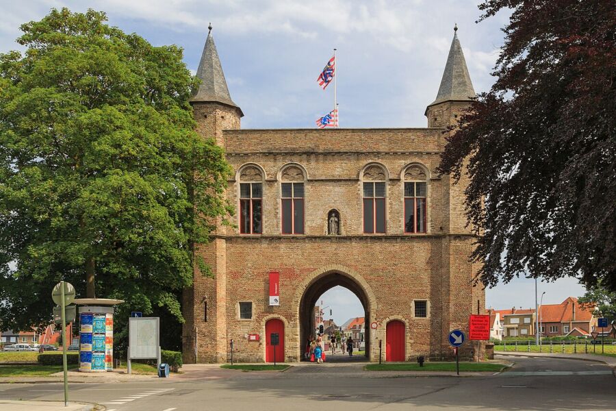 Exterior view of a large brick building in Bruges, Belgium, highlighting its architectural features and historical context.