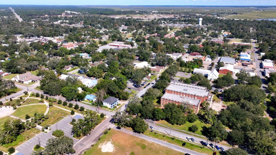 Scenic view of Brunswick, Georgia, showcasing historic architecture, marina, parks, and wetlands under a sunny sky