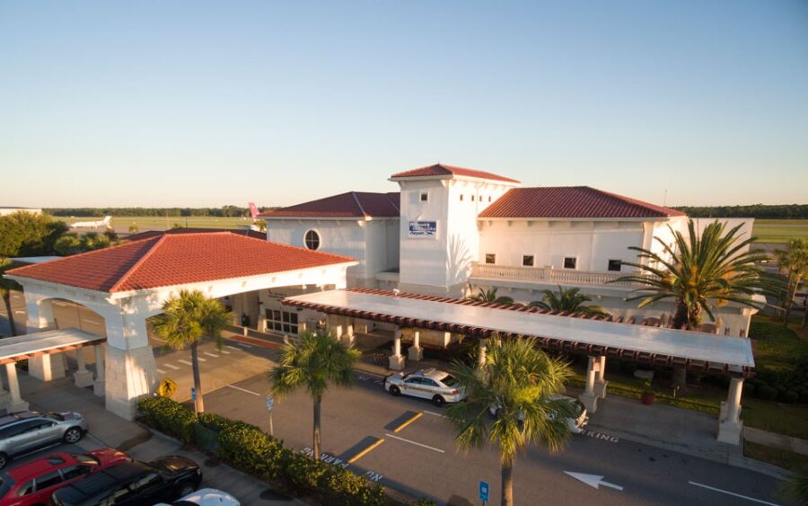 Brunswick Golden Isles Airport situated alongside a road, featuring a clear view of the terminal and surrounding area.

