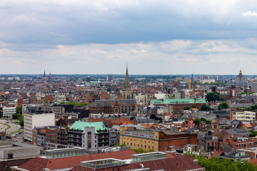 Aerial view of Brussels cityscape showcasing historic buildings and modern architecture under a clear blue sky