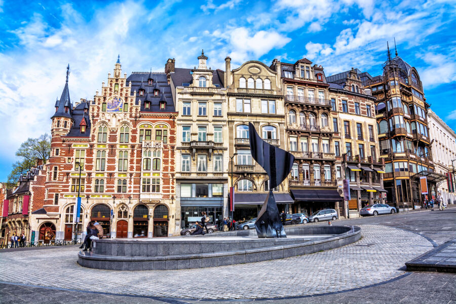 Traditional buildings line the streets of Brussels, Belgium, showcasing unique architectural styles and vibrant colors.