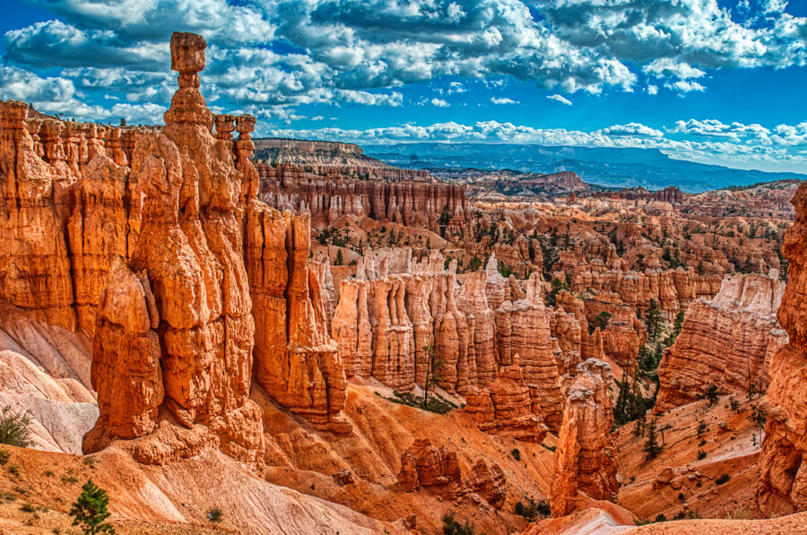 Panoramic view of Bryce Canyon's Hoodoos, featuring the iconic Thor's Hammer rock formation against a clear blue sky