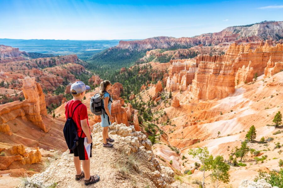Family hiking in Bryce Canyon National Park, Utah, USA looking out at a scenic view