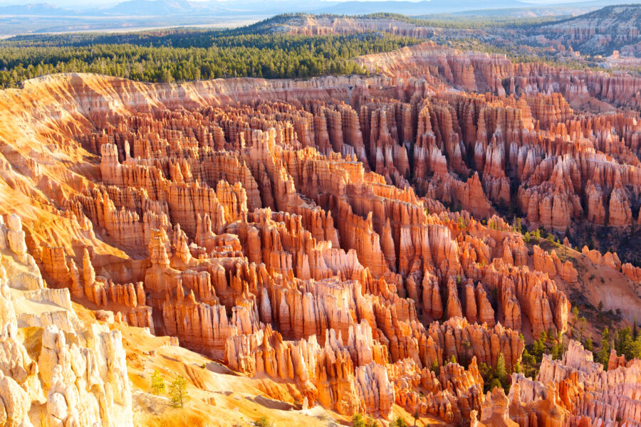 Sunrise panorama of Bryce Canyon National Park, showcasing vibrant rock formations and a colorful sky