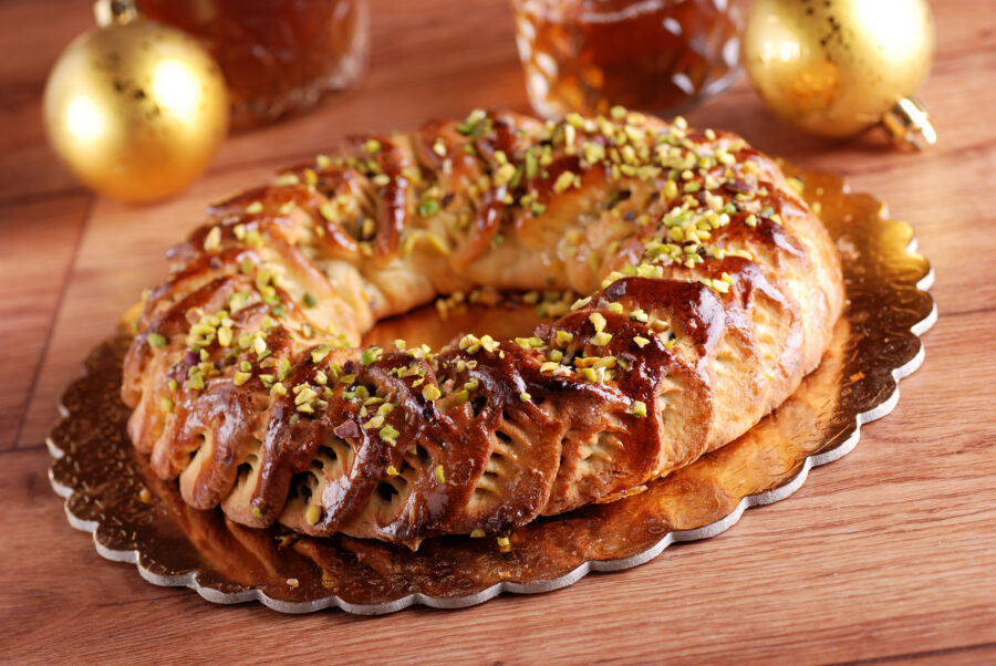 Close-up of a buccellato, a traditional Italian pastry filled with dried fruits and nuts, showcasing its rich texture and color