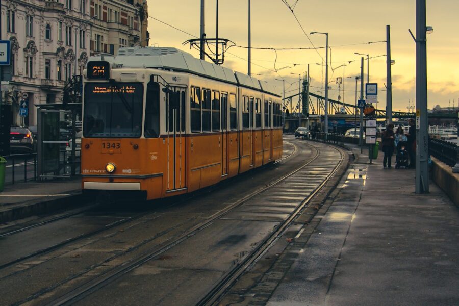 Yellow tram 1343 in Budapest, showing European architecture, public transport, and urban life.