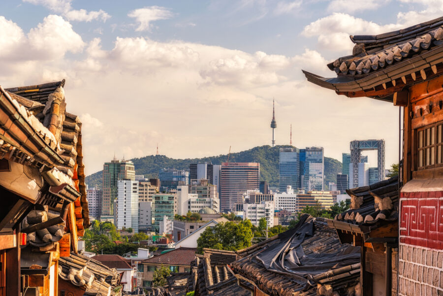 Scenic view of Bukchon Hanok Village, featuring historic hanoks amidst the vibrant cityscape of Seoul, Korea