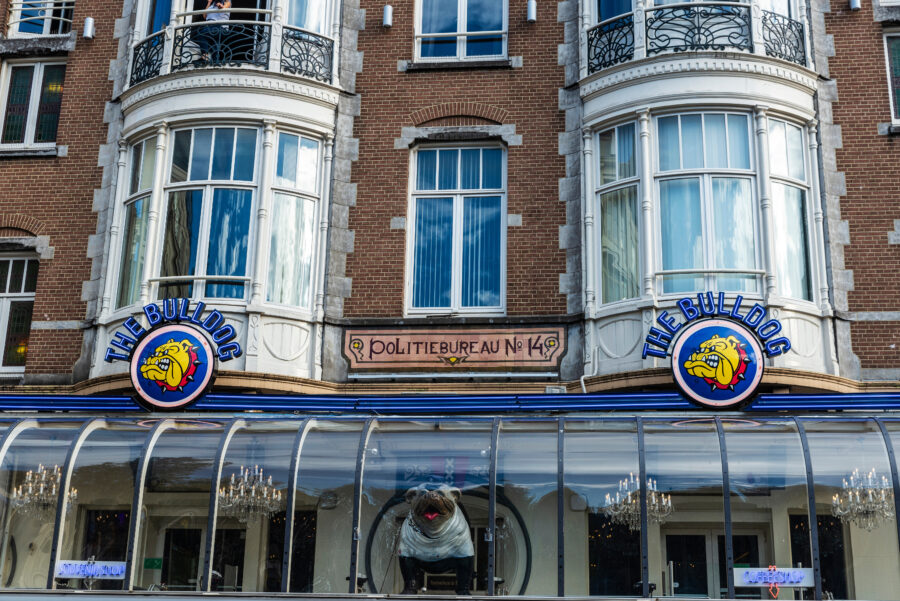 Historic brick building with large windows, featuring "The Bulldog" sign A cannabis coffee shop in Amsterdam, Netherlands