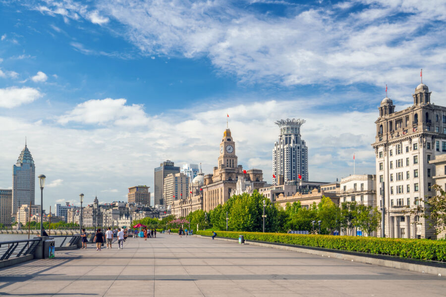 Cityscape of Shanghai at the Bund, showcasing modern skyscrapers and historic buildings along the waterfront