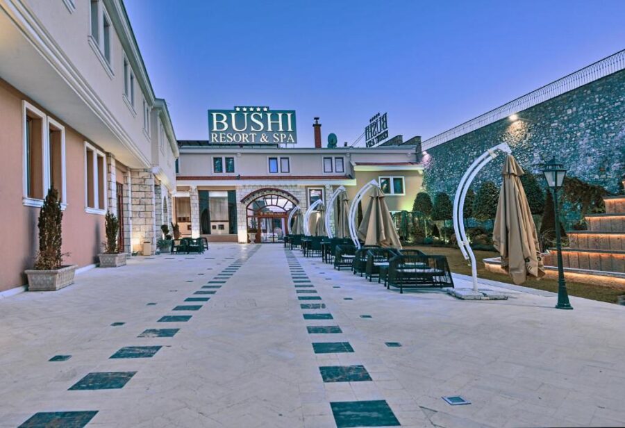 Night view of the brightly lit entrance to Bushi Resort & SPA in Skopje, inviting guests with its warm glow.