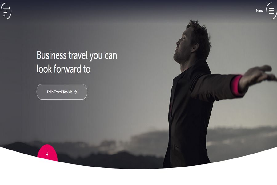 Businessman in suit embraces travel opportunities with vibrant, dawn-lit mountain background.