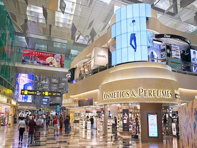 Luxurious airport terminal with high-end shopping and vibrant atmosphere.