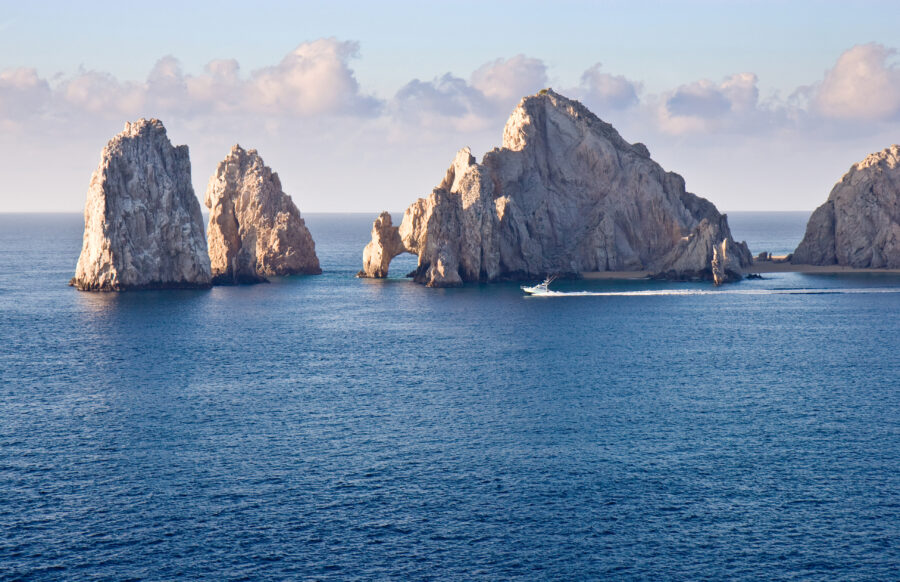 Rock formations at Cabo San Lucas, Mexico, showcasing unique geological shapes against a clear blue sky.