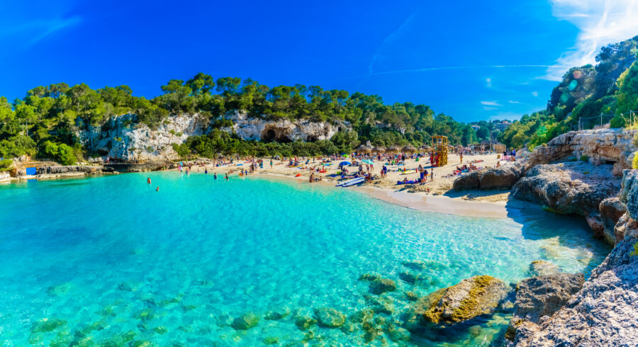 Scenic view of Cala Llombards beach in Mallorca, showcasing pristine turquoise waters and a tranquil shoreline