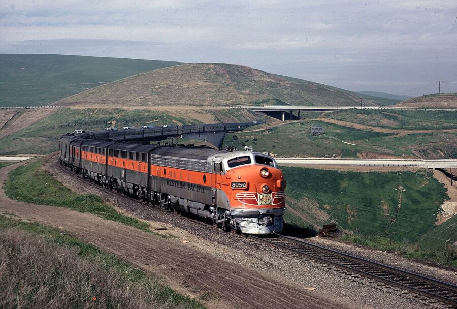 California Zephyr train traveling along the tracks, showcasing its sleek design against a scenic backdrop.