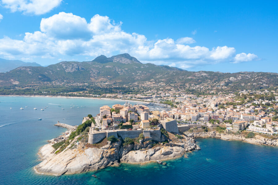 Scenic landscape of Calvi, Corsica, France, featuring its famous cliffside architecture and vibrant blue sea.