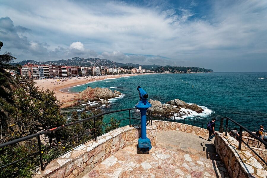 Scenic blue fountain atop a hill, overlooking the beach on the Camí de Ronda Hiking Trail, Costa Brava, Spain.