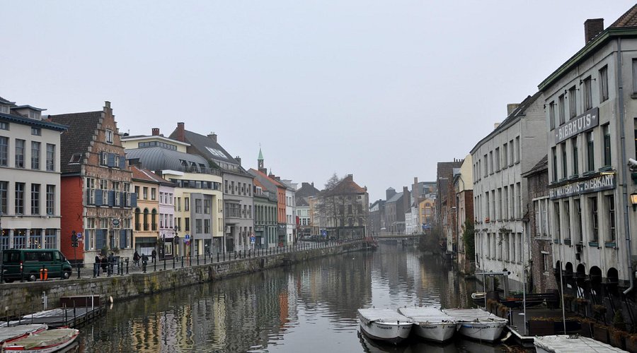Historic Patershol canal and quay with moored boats and winter city buildings.
