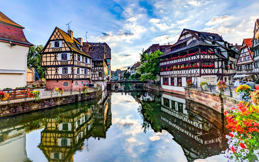 Petite France canal with half-timbered houses and stone bridge in Strasbourg.