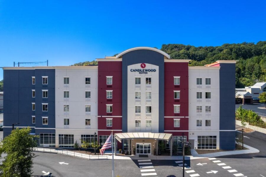 Comfort Inn hotel exterior in Candlewood Suites - Asheville Downtown by IHG, showcasing its welcoming entrance and surrounding greenery.