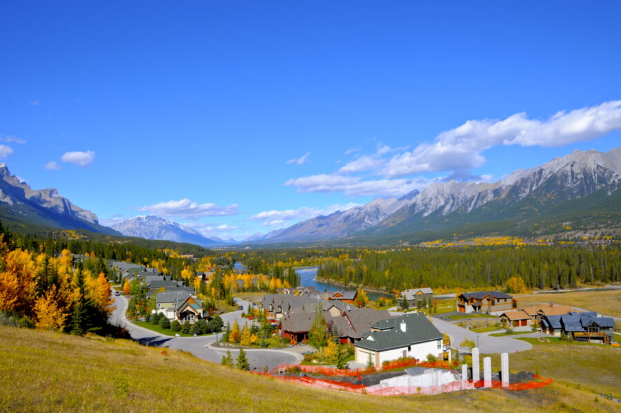 Bright blue sky dotted with white clouds above Canmore, Canada, creating a tranquil and inviting atmosphere.