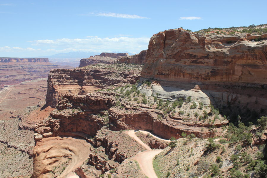 Expansive view of Canyonlands National Park showcasing rugged cliffs, canyons, and a vibrant sunset sky.