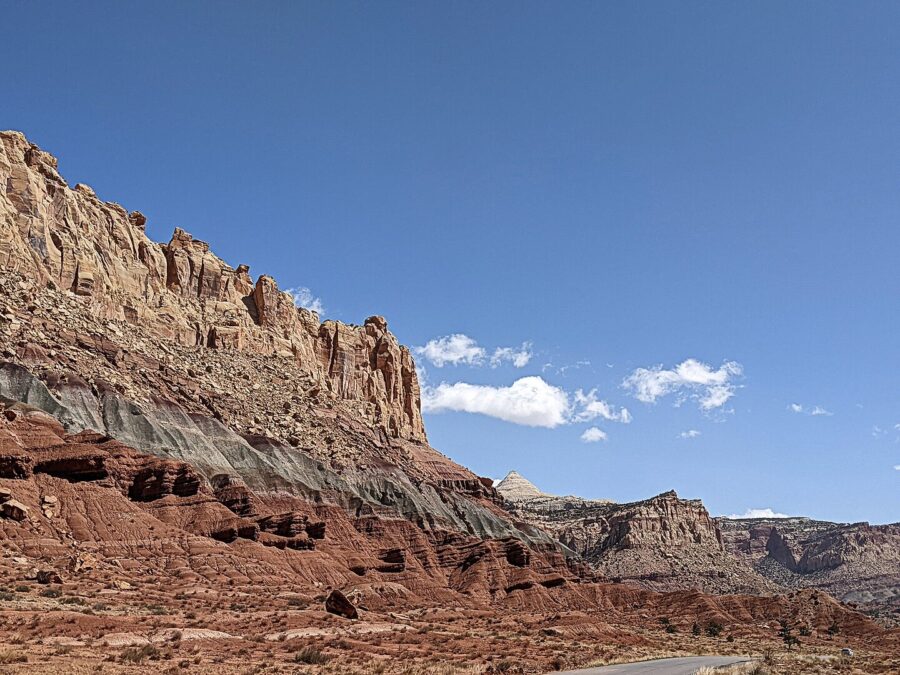 Scenic road traversing a vibrant canyon landscape in Capitol Reef National Park, highlighting natural geological beauty.