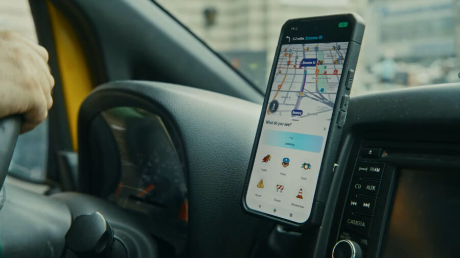 Smartphone running Waze navigation on car dashboard while driving in Germany.