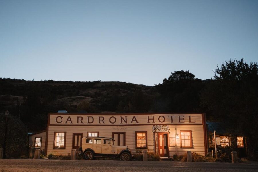 Cardrona Hotel vintage facade with classic car at dusk in rural New Zealand countryside.