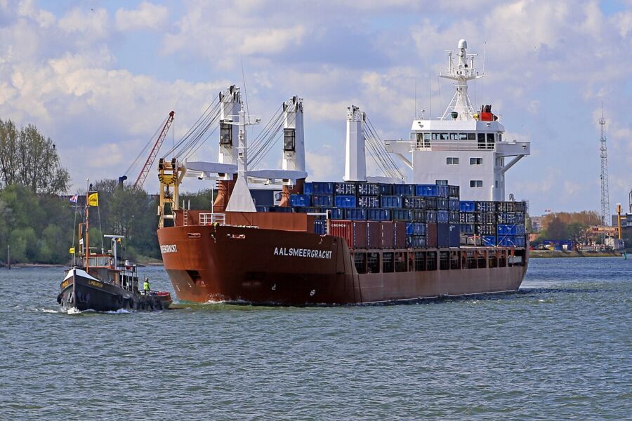 Large cargo ship sailing on the water, showcasing its massive structure against the blue sea.
