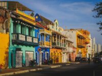 Colorful colonial architecture and lively street scene in historic Cartagena.