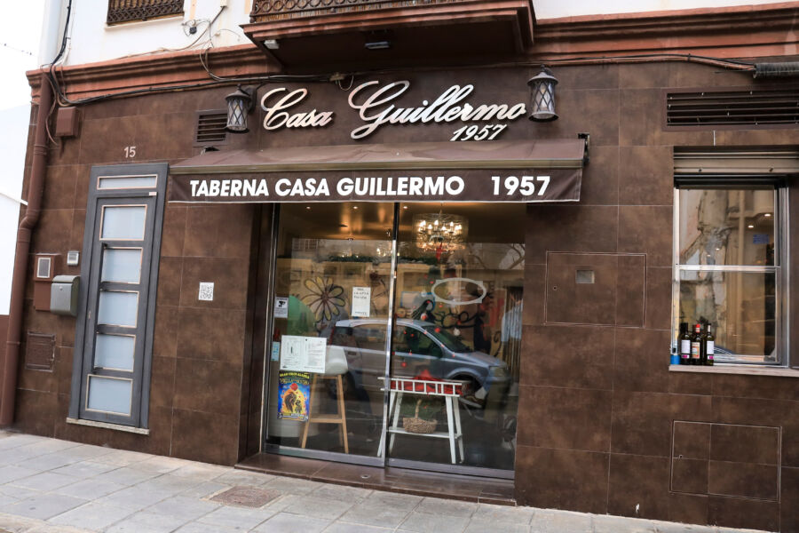 Exterior view of Casa Guillermo, a renowned tavern in The Cabanyal neighborhood of Valencia, showcasing its coastal charm