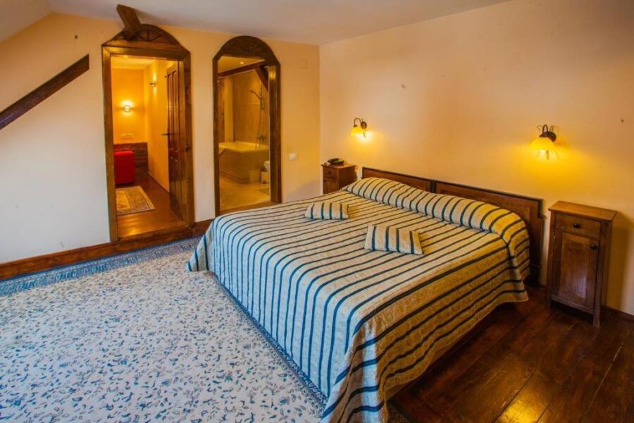 Interior of a hotel room at Casa Wagner, Brasov, Romania, showcasing a comfortable bed and inviting decor.