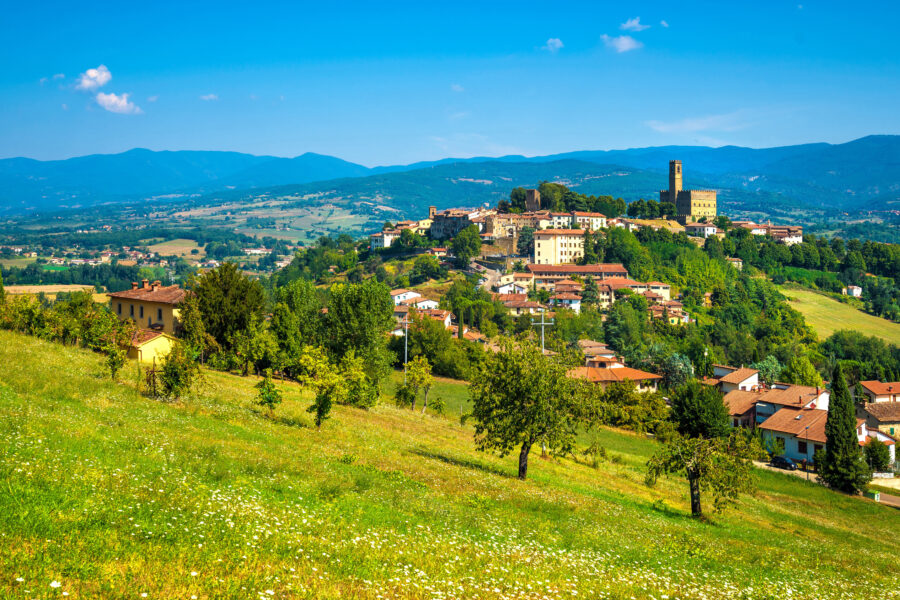 Scenic panorama of Poppi village in Casentino, Arezzo, highlighting medieval buildings against the backdrop of Tuscany's hills