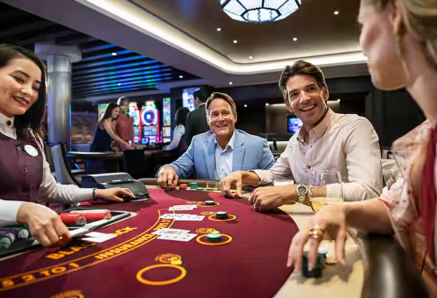 Blackjack game in casino with smiling dealer and enthusiastic players enjoying the lively atmosphere.