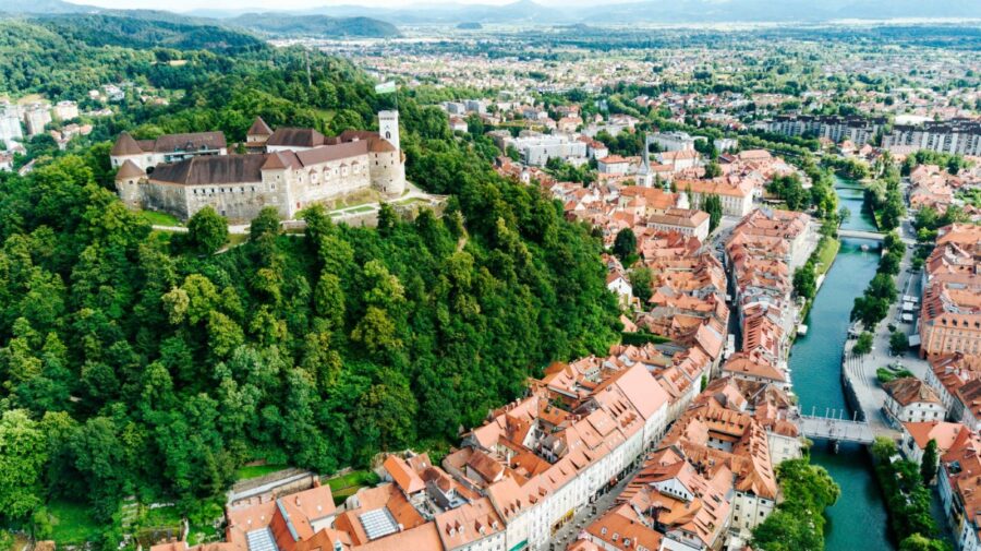 Aerial view of Ljubljana Castle, historic architecture, and lush landscape in Slovenia.