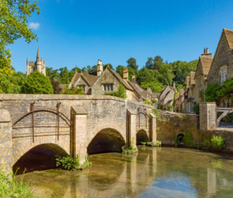 Scenic landscape of Castle Combe, featuring historic stone architecture and vibrant greenery in the heart of Wiltshire, England