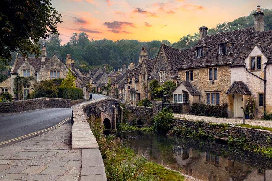 Charming Castle Combe village in Wiltshire, featuring historic stone buildings and picturesque countryside scenery.
