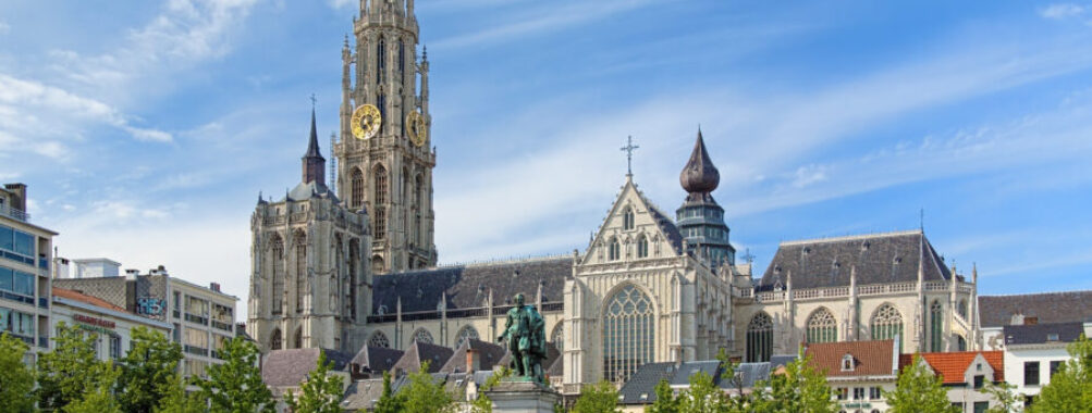 Cathedral and statue of Peter Paul Rubens in Antwerp, showcasing intricate architecture and historical significance.