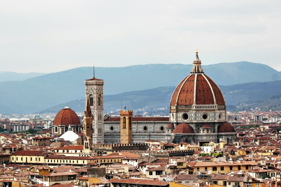 Florence skyline with the Duomos red-tiled dome and medieval terracotta roofs.