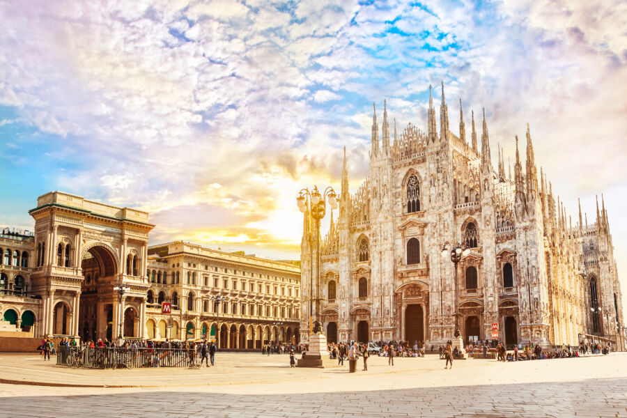 Early morning sunlight illuminates Milan's Cathedral Duomo and Vittorio Emanuele Gallery in Piazza Duomo