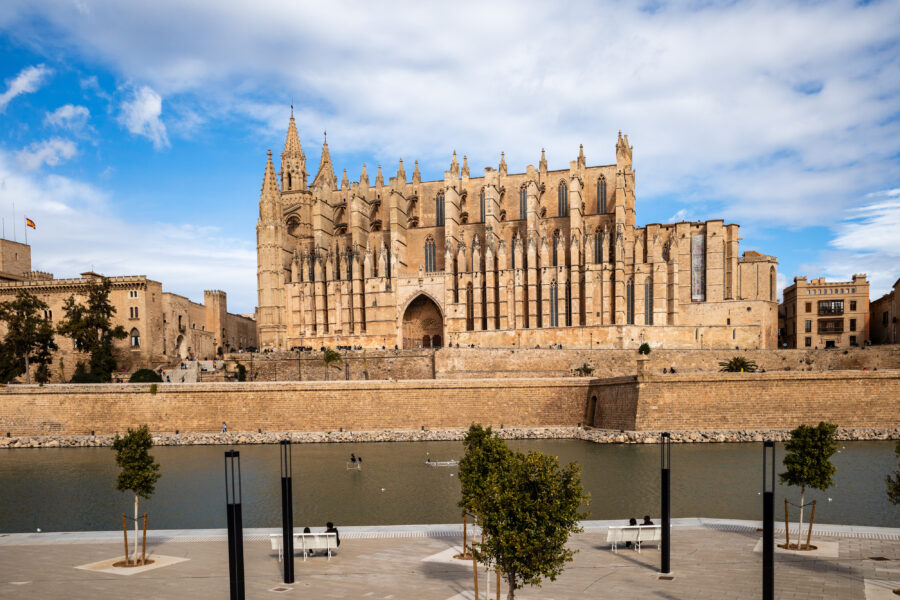 Scenic view of the Cathedral of Santa Maria of Palma, showcasing its Gothic architecture against a clear blue sky